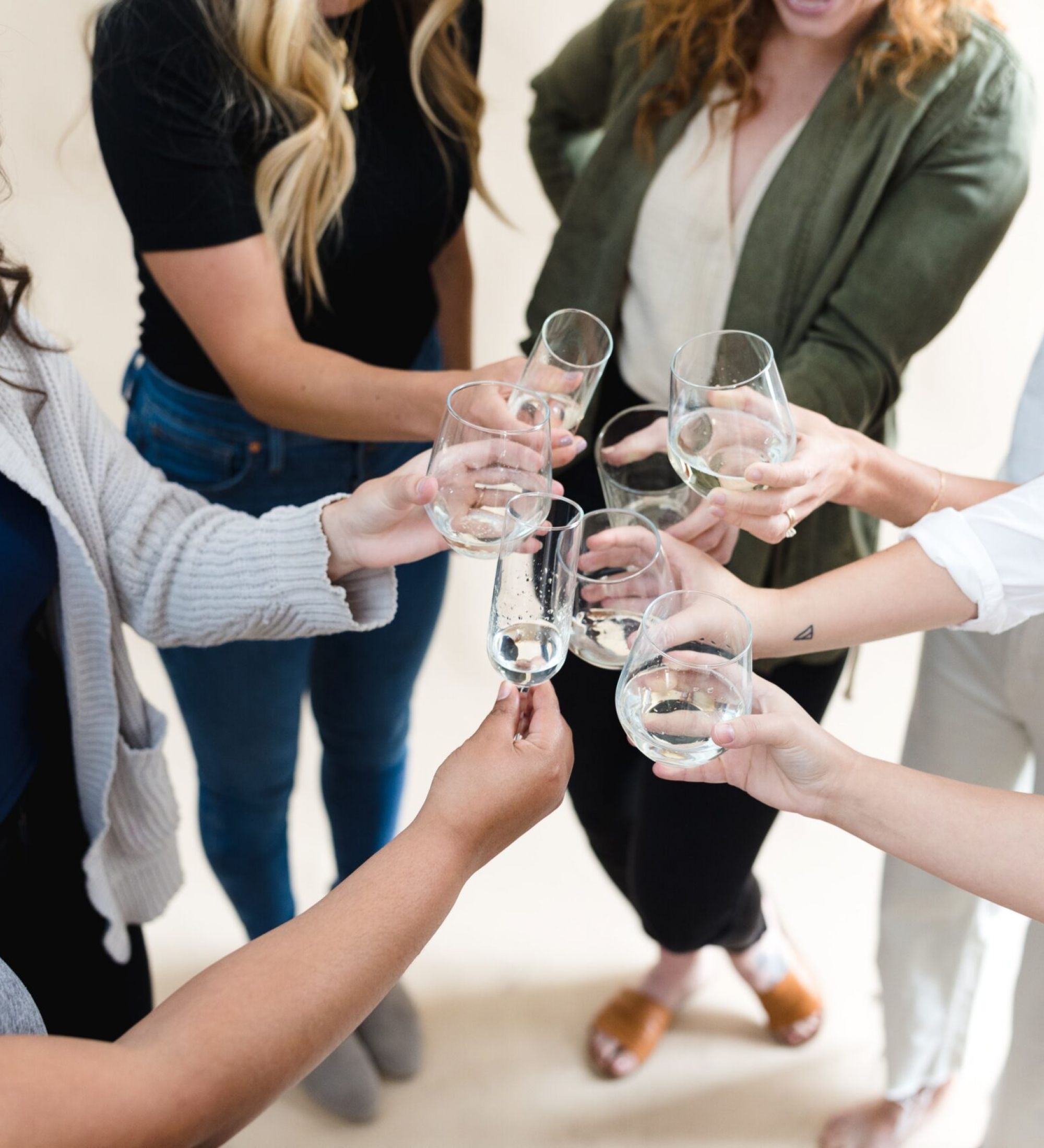 friends clinking wine glasses together at Moment