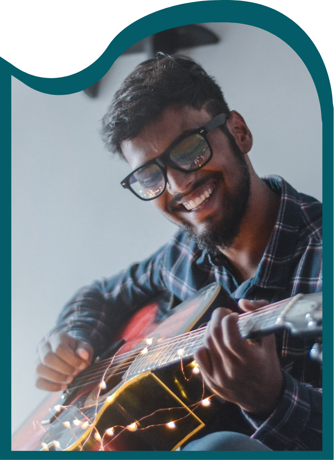 Moment Minneapolis Apartments Man Playing Guitar Smiling